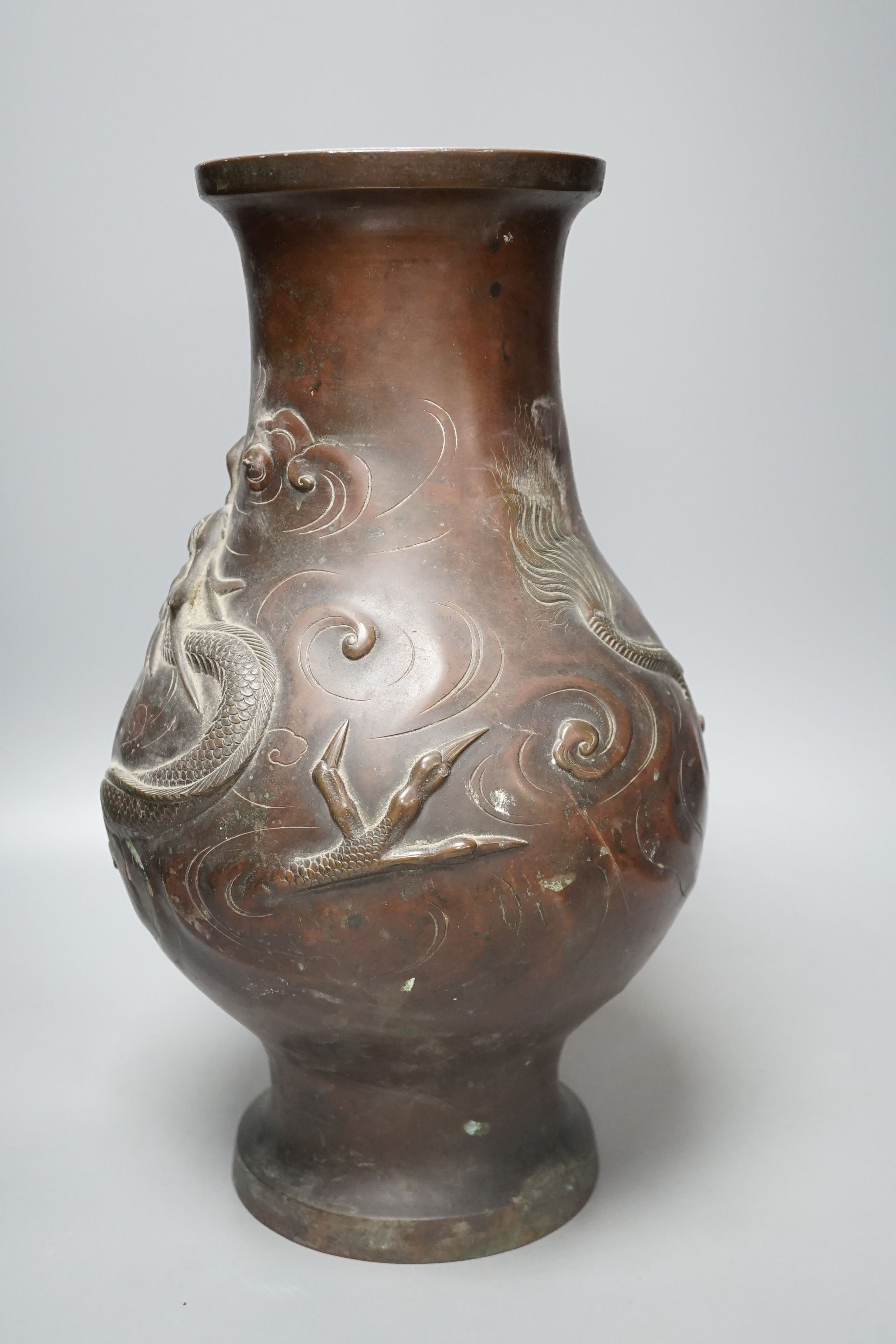 A large 19th century Japanese bronze dragon designed vase, 40cms high.